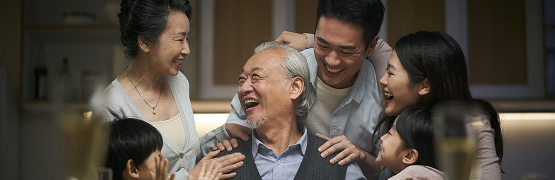 happy three generation asian family celebrating grandpa's birthday at home
